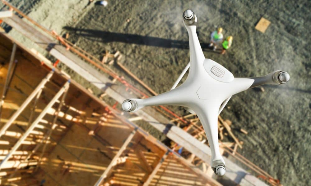 Drone performing LiDAR mapping over an urban construction site, collecting elevation data for zoning and planning in high-density cities.