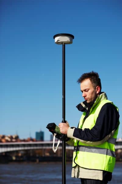 Licensed land surveyor using GPS equipment during a FEMA elevation survey in San Francisco