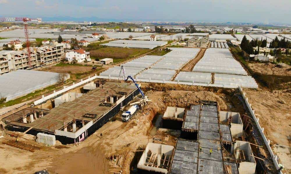 Aerial view of a construction survey site with foundations and equipment showing how surveys guide large infrastructure projects