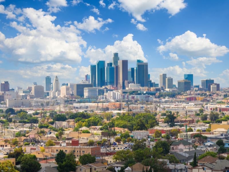 Downtown Los Angeles skyline with residential neighborhoods in the foreground, showing urban areas at risk of boundary and fire hazard survey concerns