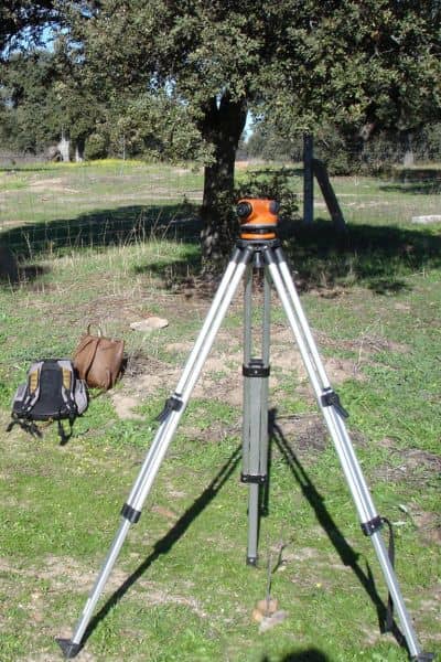 Surveying equipment set up to measure property elevation after heavy rain
