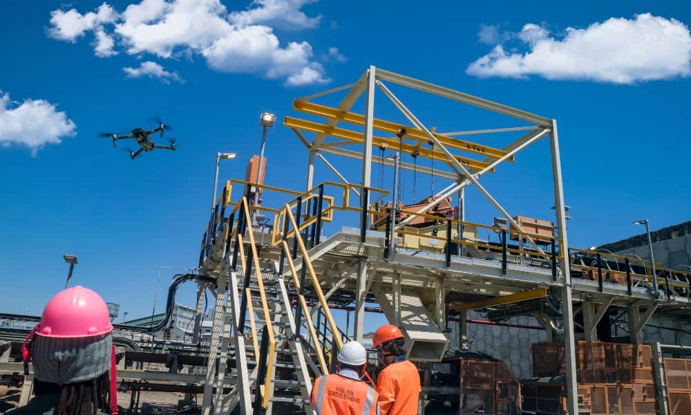 Engineers monitoring drone surveying operations at a construction site
