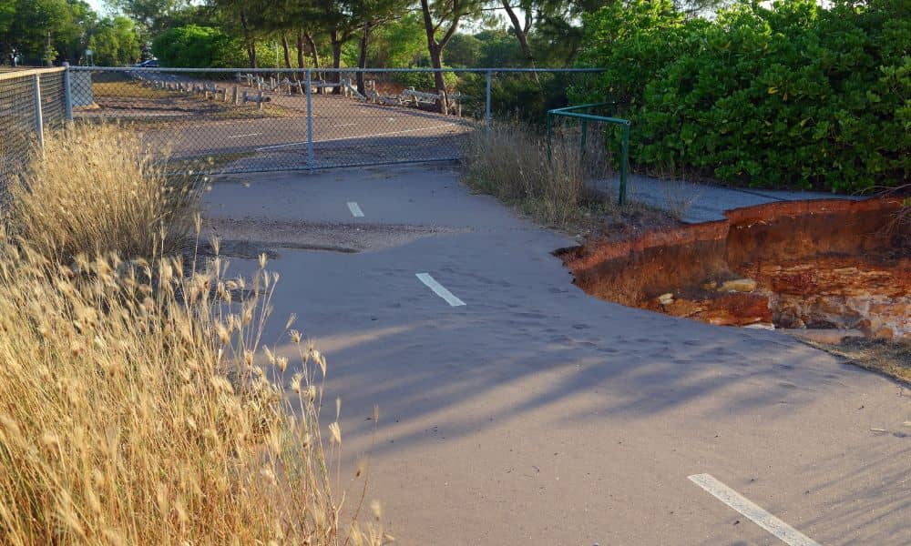 A collapsed pathway caused by soil erosion, showing why an elevation survey helps identify slope risks and drainage problems