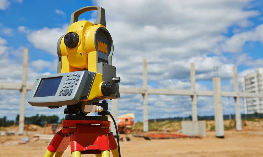 Surveying equipment set up at a commercial development site during an ALTA land title survey