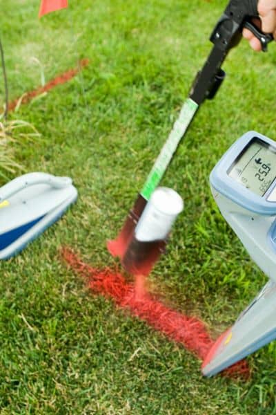 Surveyor marking a boundary line on the ground using equipment during a property line survey